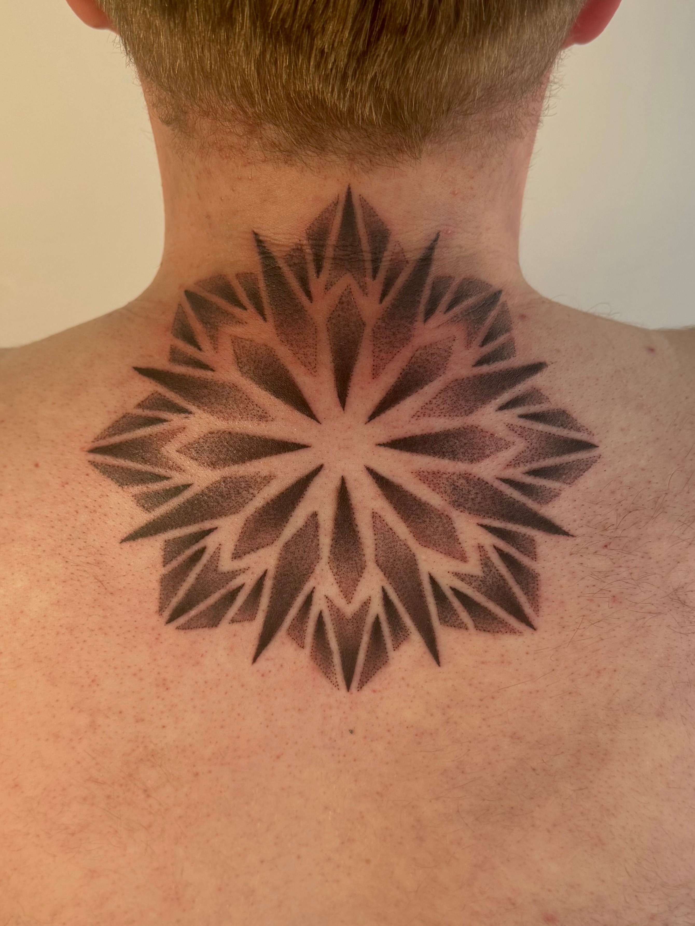 Geometric mandala back of neck tattoo by Byron Rojas