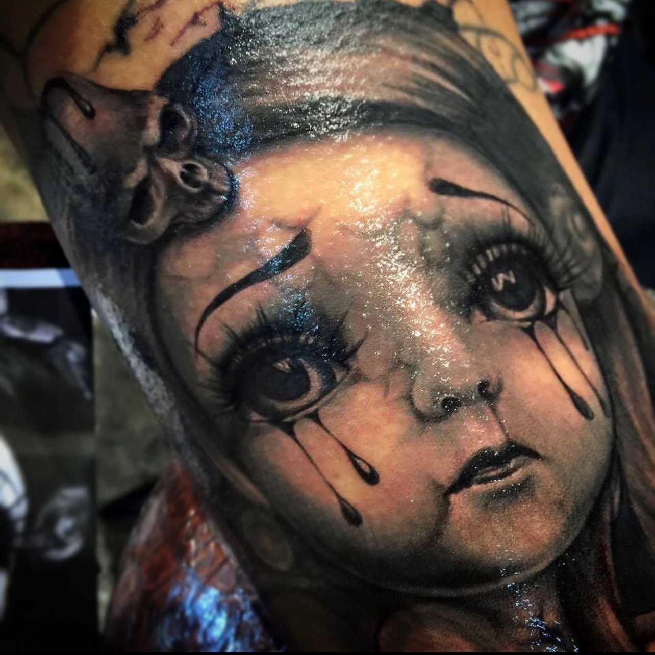 Black and grey creepy doll face tattoo by Ruthless
